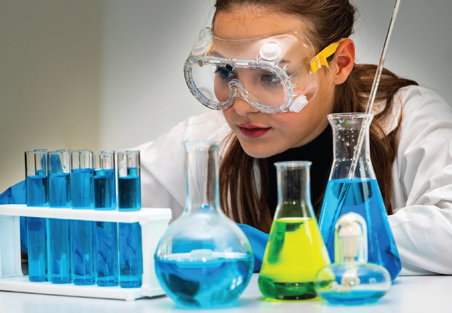 A photo of a female scientists with beakers