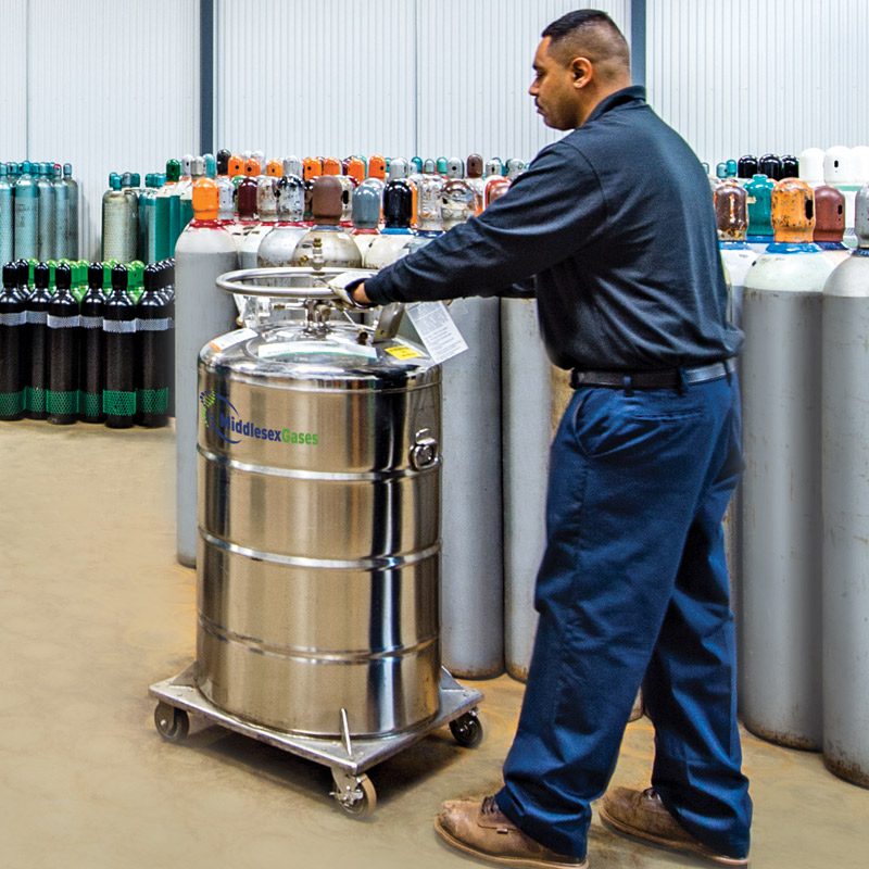 A photo of a male working with a gas tank