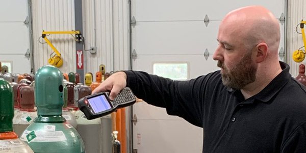 A Middlesex employee scanning a bar code on a gas canister in 1993