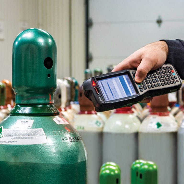 A photo of a Middlesex employee scanning the bar code on a cannister